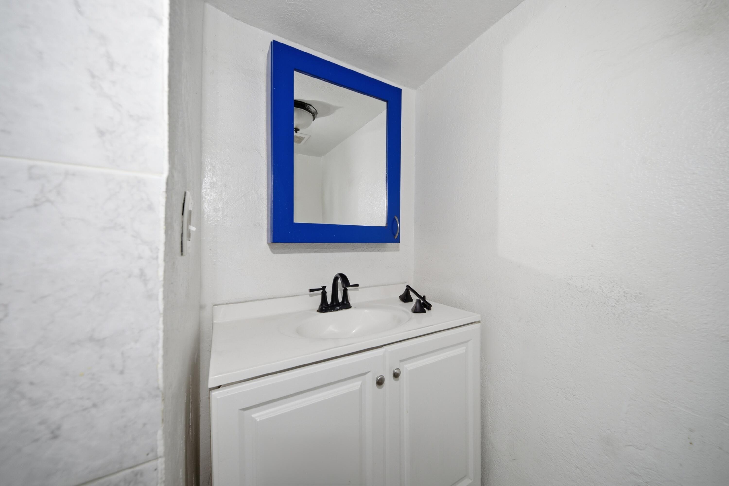 1796 Northwest 112th Street Miami, FL 33167 - Photo 21 of 25 a bathroom with a sink and a mirror