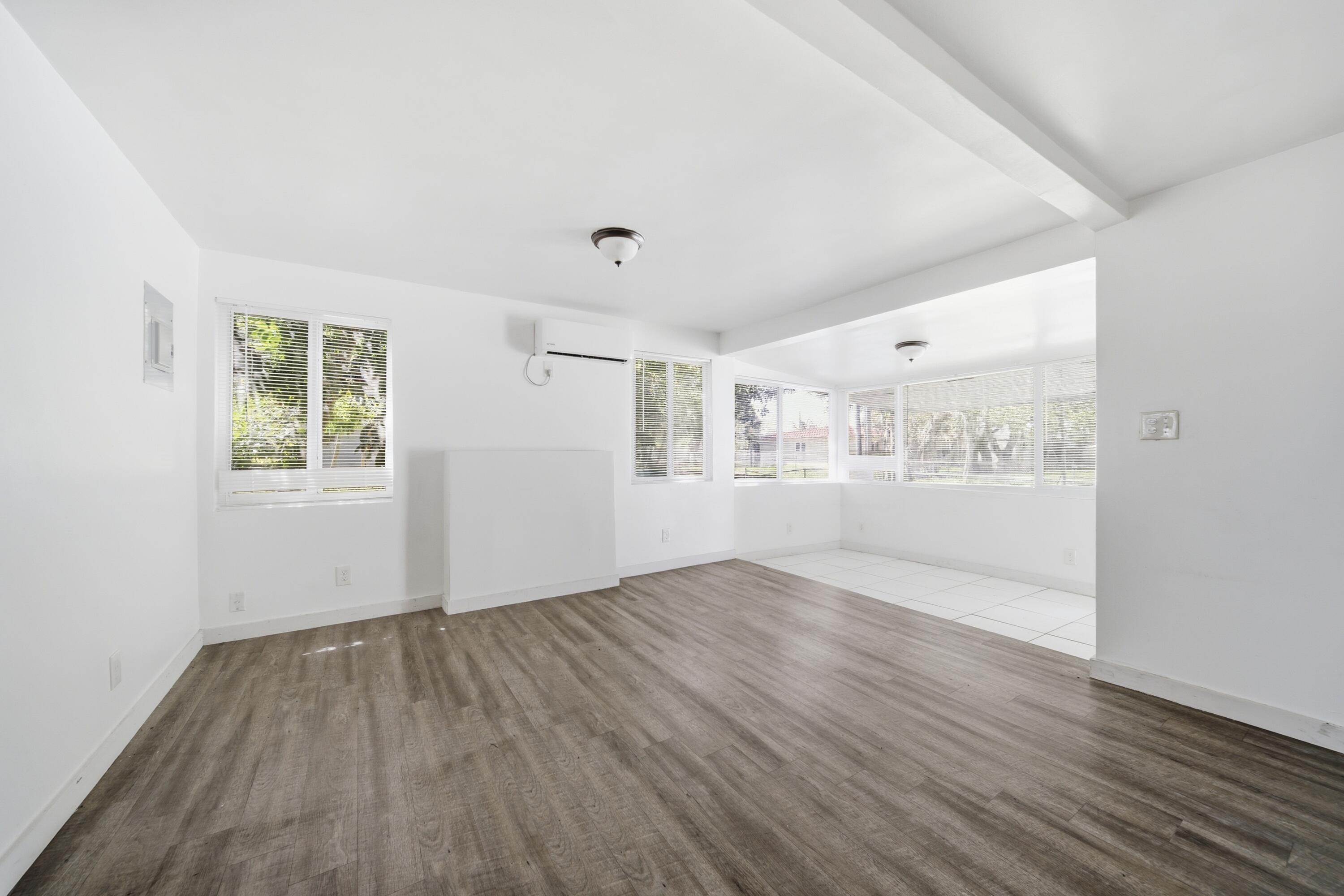 1796 Northwest 112th Street Miami, FL 33167 - Photo 23 of 25 an empty room with wooden floor and windows