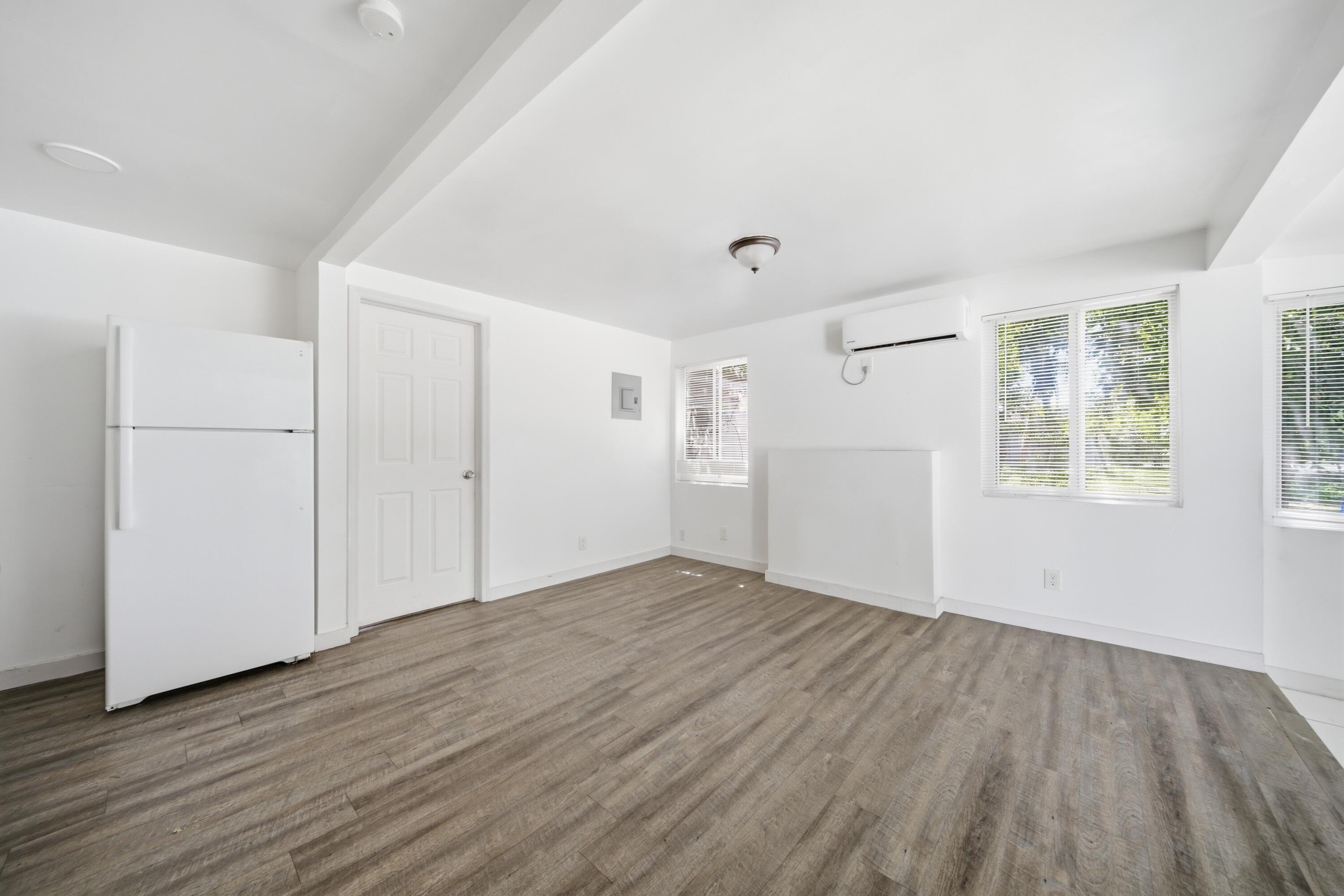 1796 Northwest 112th Street Miami, FL 33167 - Photo 24 of 25 an empty room with wooden floor and windows