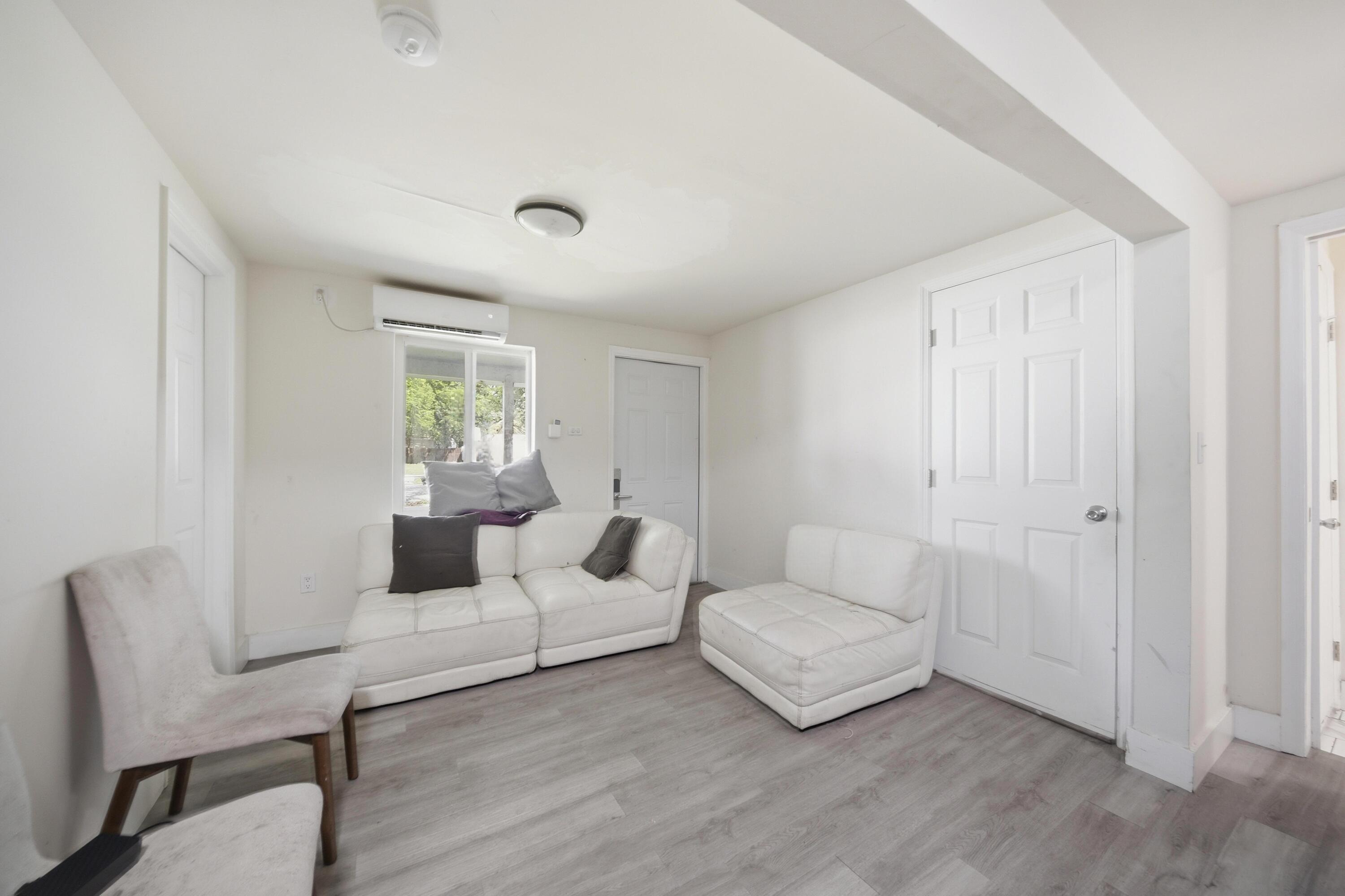 1796 Northwest 112th Street Miami, FL 33167 - Photo 3 of 25 a living room with furniture and a wooden floor