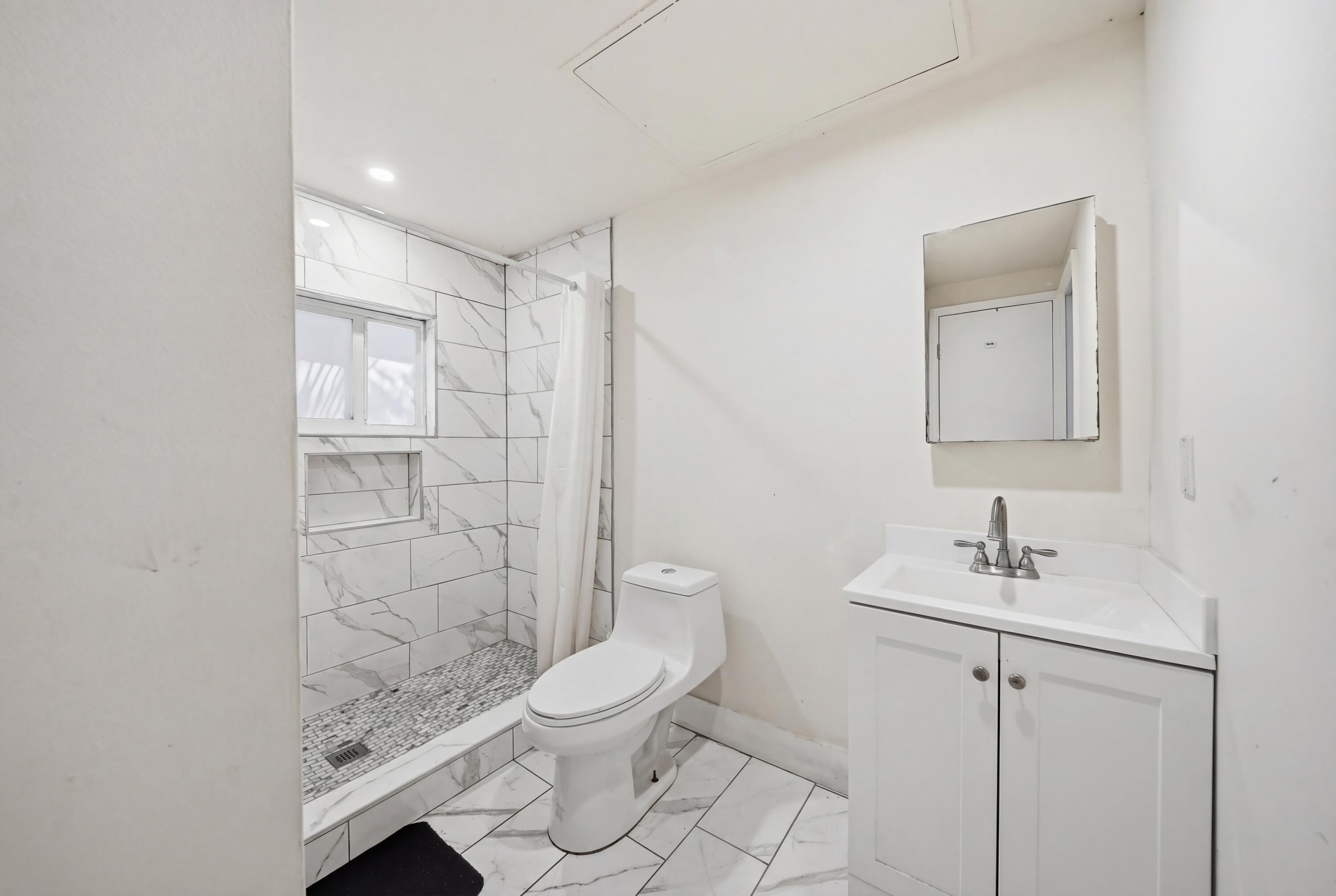 1796 Northwest 112th Street Miami, FL 33167 - Photo 4 of 25 a bathroom with a toilet sink and shower