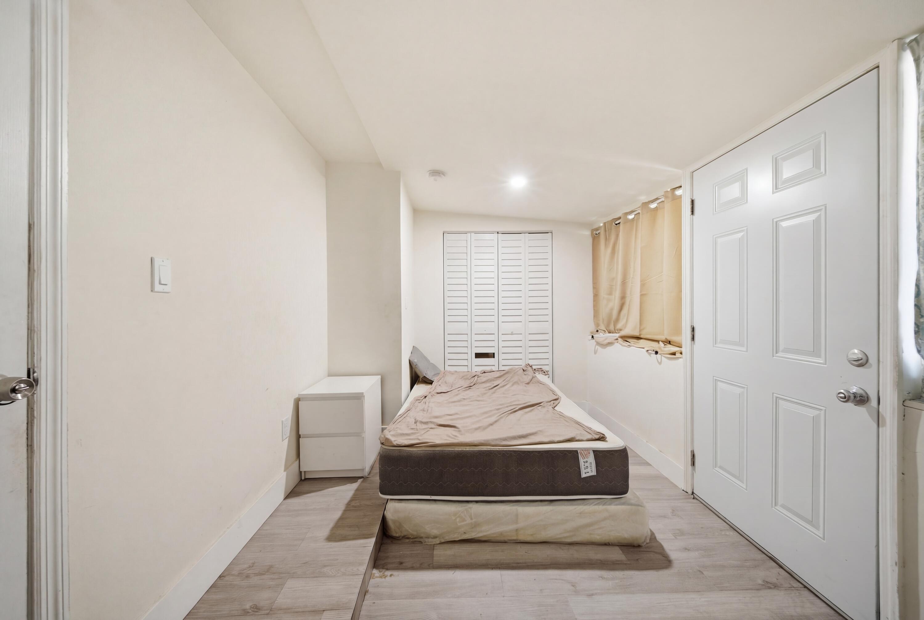 1796 Northwest 112th Street Miami, FL 33167 - Photo 7 of 25 a bedroom with a bed and a window
