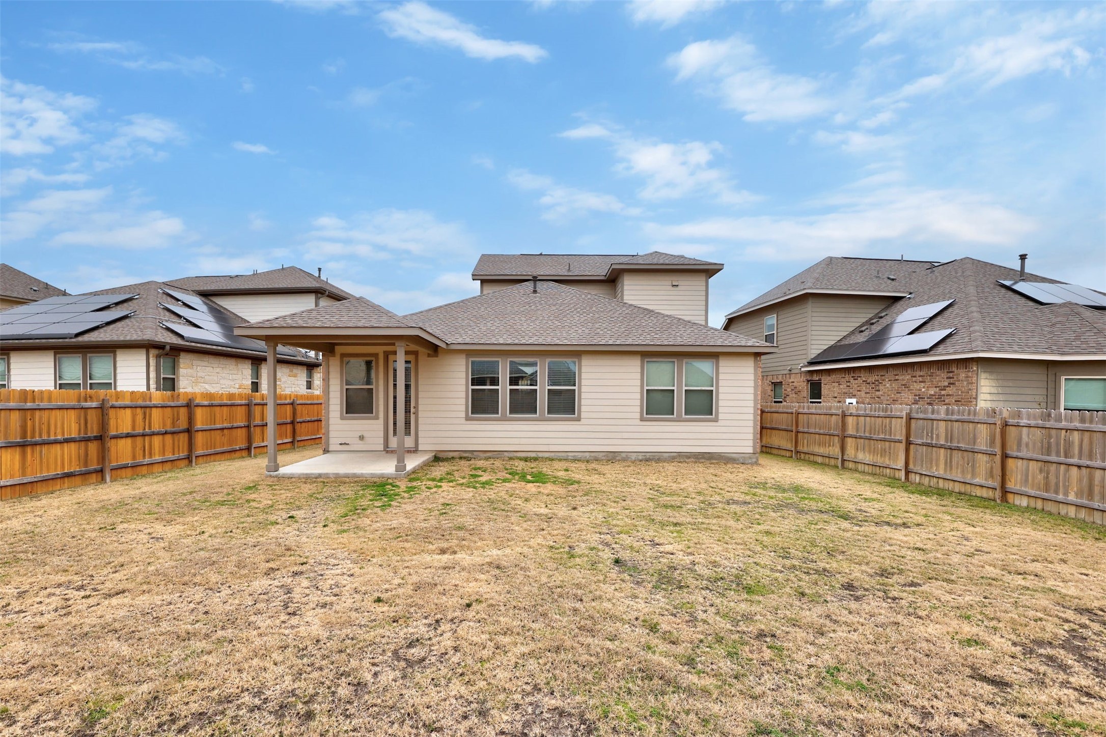 307 Simmental Loop Hutto, TX 78634 - Photo 29 of 34 A private, fenced backyard offers a concrete patio and ample space for outdoor living.