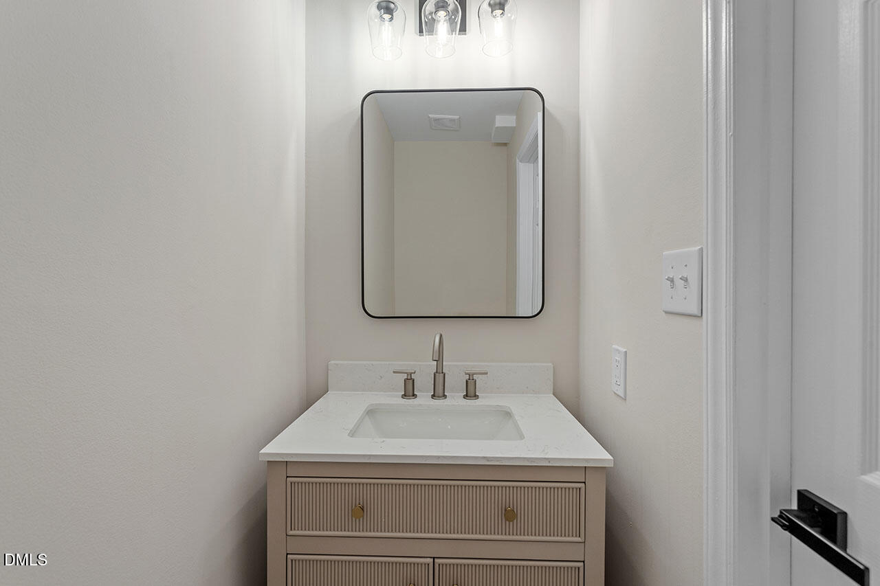 389 East Williams Street Angier, NC 27501 - Photo 12 of 29 a bathroom with a sink and a mirror