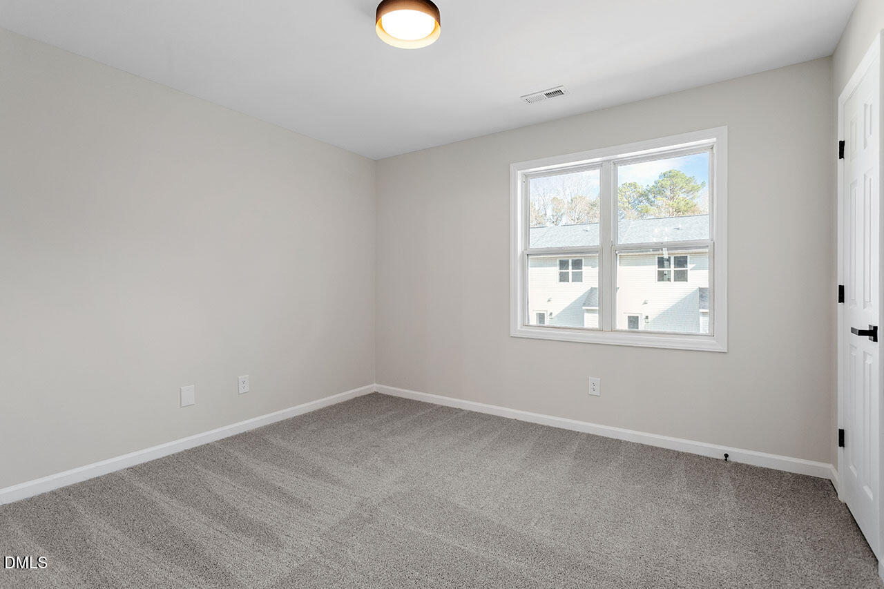 389 East Williams Street Angier, NC 27501 - Photo 26 of 29 an empty room with a window