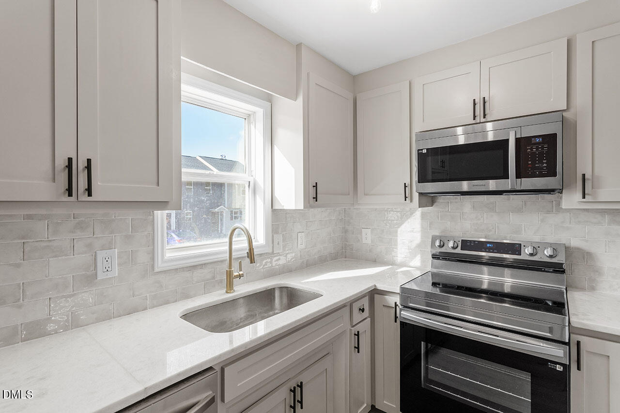 389 East Williams Street Angier, NC 27501 - Photo 8 of 29 a kitchen with a sink and steel appliances