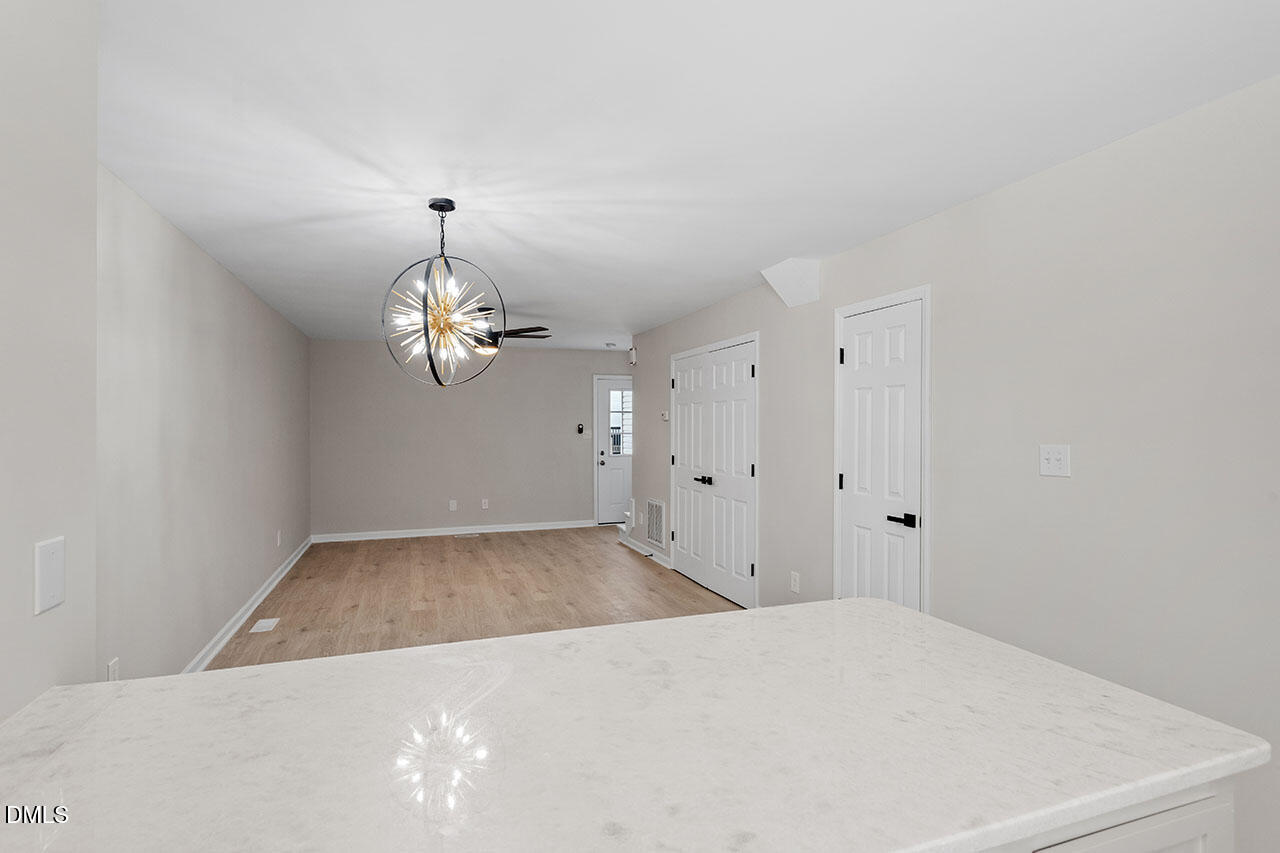 389 East Williams Street Angier, NC 27501 - Photo 10 of 29 a view of a chandelier fan and hardwood floor