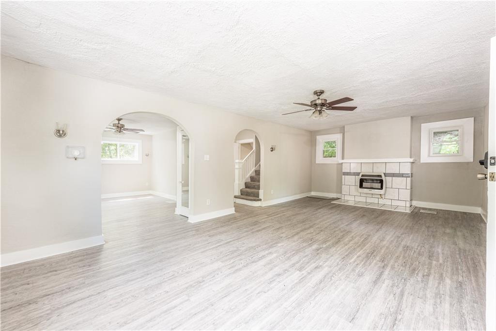 718 Maytide Street Pittsburgh, PA 15227 - Photo 2 of 19 a view of a livingroom with wooden floor a ceiling fan and windows