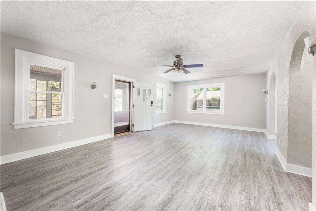 718 Maytide Street Pittsburgh, PA 15227 - Photo 3 of 19 a view of an empty room with a window and wooden floor