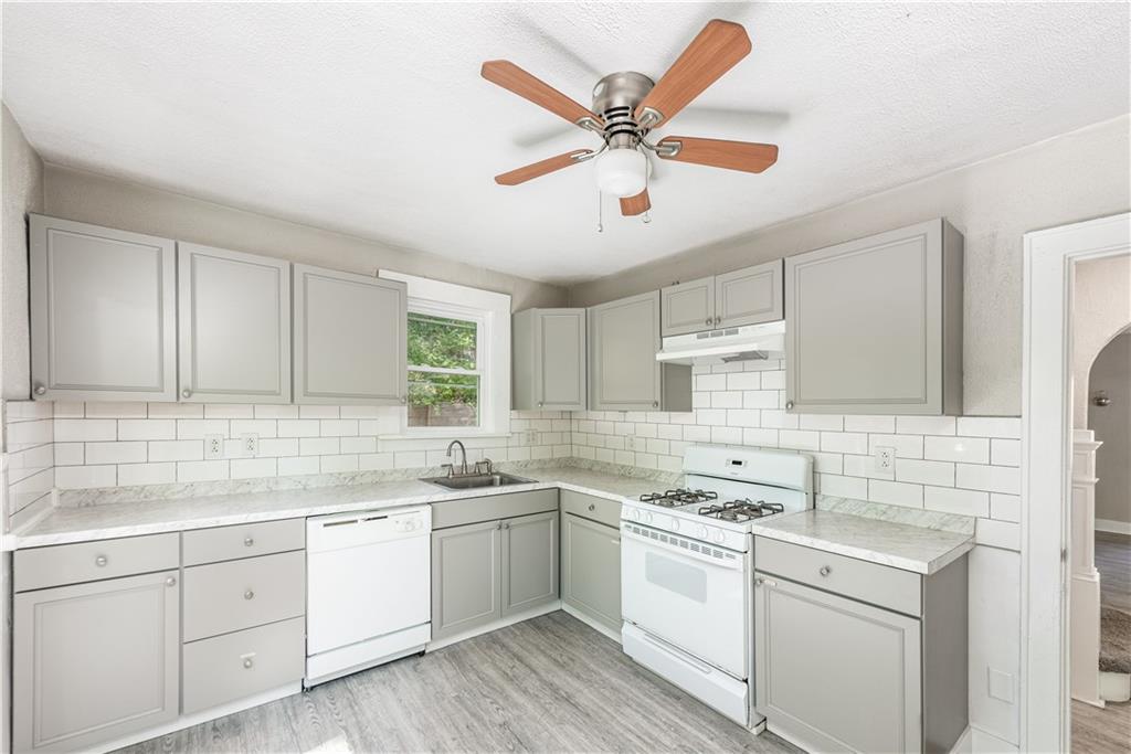 718 Maytide Street Pittsburgh, PA 15227 - Photo 5 of 19 a kitchen with a sink cabinets stainless steel appliances and a window