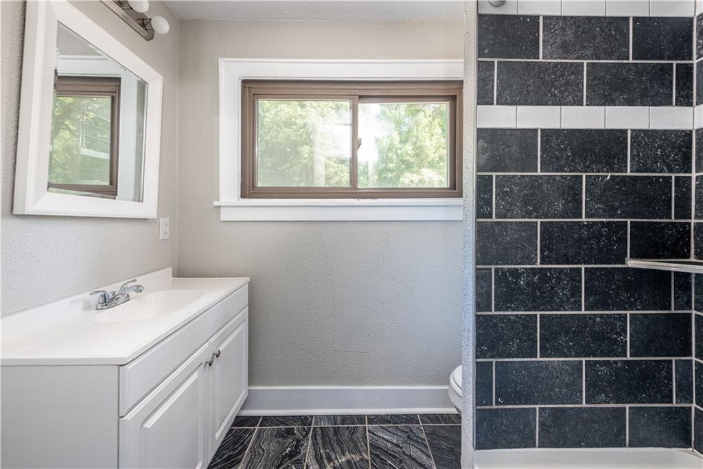 718 Maytide Street Pittsburgh, PA 15227 - Photo 7 of 19 a bathroom with a sink a toilet and a window