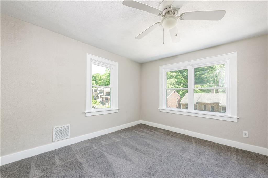 718 Maytide Street Pittsburgh, PA 15227 - Photo 9 of 19 an empty room with windows and fan