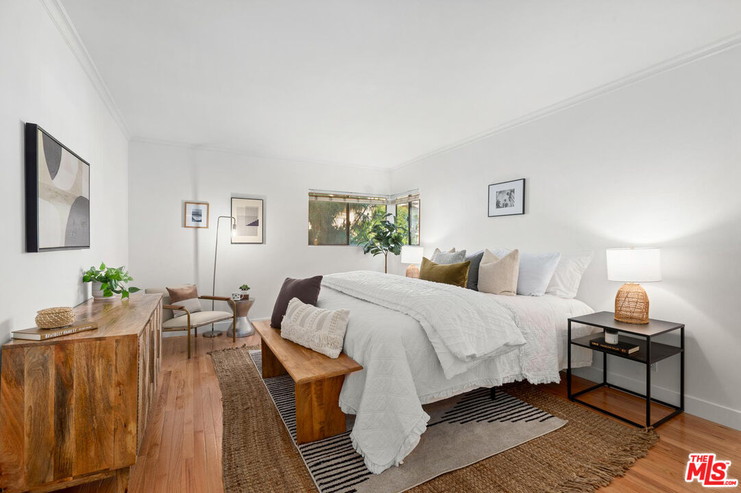 1710 Malcolm Avenue, Unit 101 Los Angeles, CA 90024 - Photo 11 of 18 a spacious bedroom with a bed and wooden floor