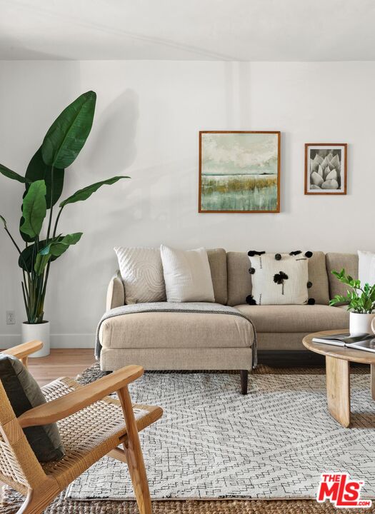 1710 Malcolm Avenue, Unit 101 Los Angeles, CA 90024 - Photo 3 of 18 a living room with furniture and a potted plant