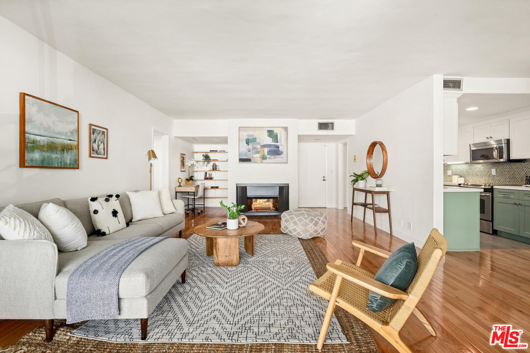 1710 Malcolm Avenue, Unit 101 Los Angeles, CA 90024 - Photo 4 of 18 a living room with furniture and a wooden floor