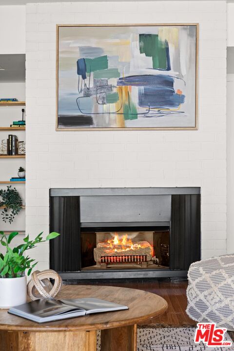 1710 Malcolm Avenue, Unit 101 Los Angeles, CA 90024 - Photo 5 of 18 a living room with furniture and a fireplace