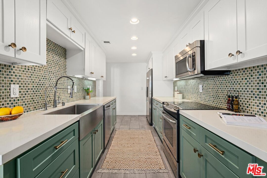 1710 Malcolm Avenue, Unit 101 Los Angeles, CA 90024 - Photo 9 of 18 a kitchen with a sink stove top oven and cabinets