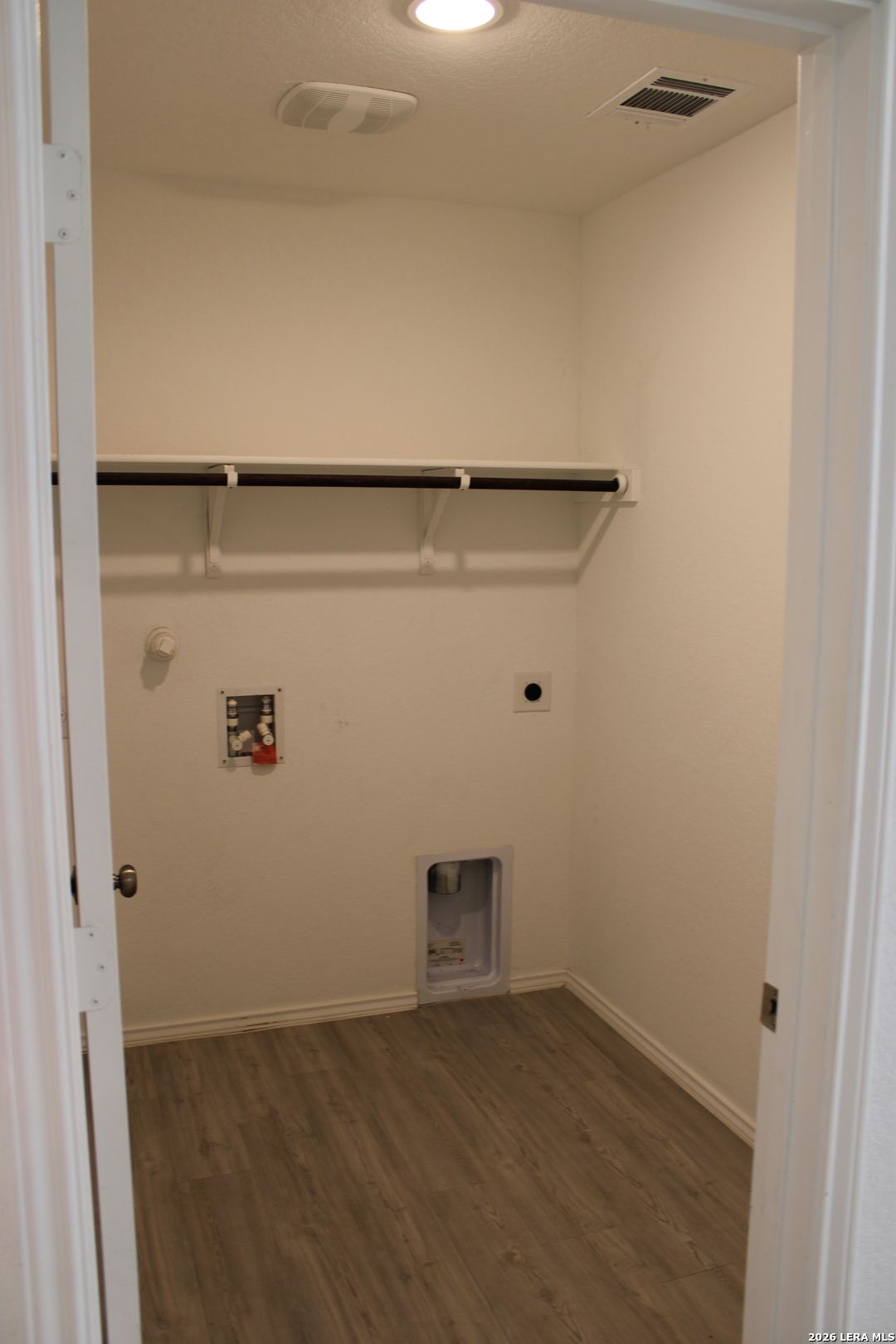 124 Horseshoe Trail Pleasanton, TX 78064 - Photo 11 of 16 a view of storage and utility room with wooden floor