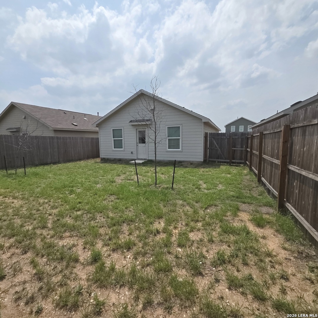 124 Horseshoe Trail Pleasanton, TX 78064 - Photo 13 of 16 a house view with garden space and wooden fence