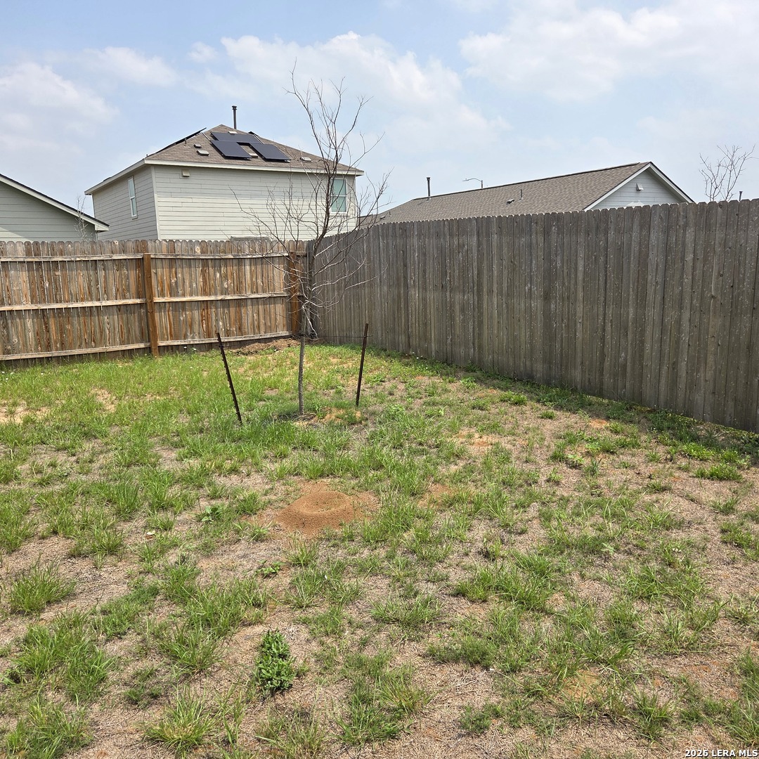 124 Horseshoe Trail Pleasanton, TX 78064 - Photo 14 of 16 a view of backyard with wooden fence