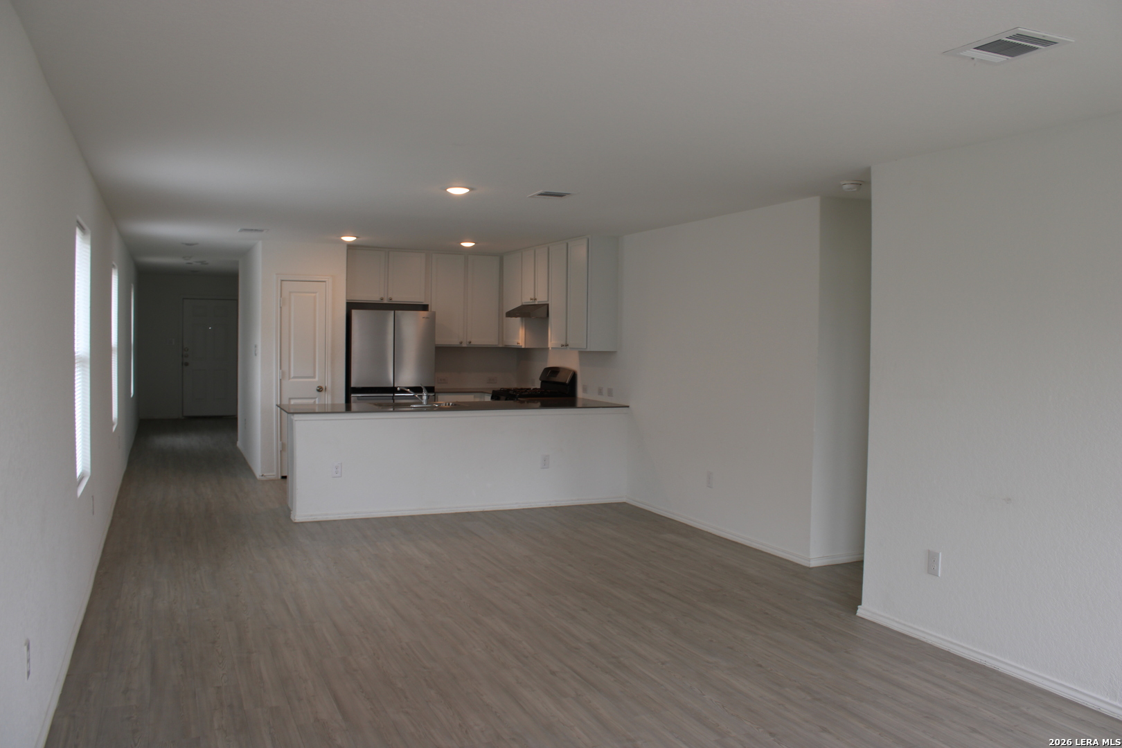 124 Horseshoe Trail Pleasanton, TX 78064 - Photo 5 of 16 a view of kitchen with wooden floor