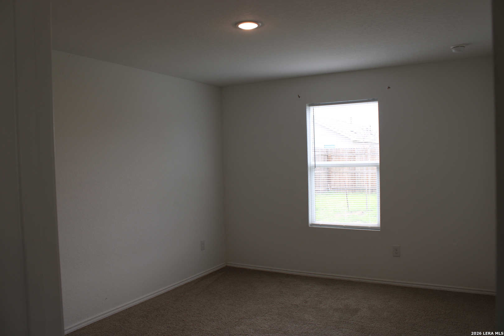 124 Horseshoe Trail Pleasanton, TX 78064 - Photo 6 of 16 an empty room with a window