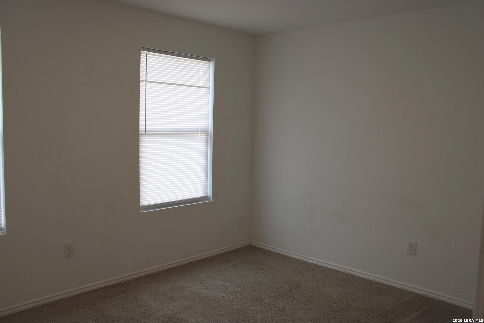 124 Horseshoe Trail Pleasanton, TX 78064 - Photo 8 of 16 an empty room with a window