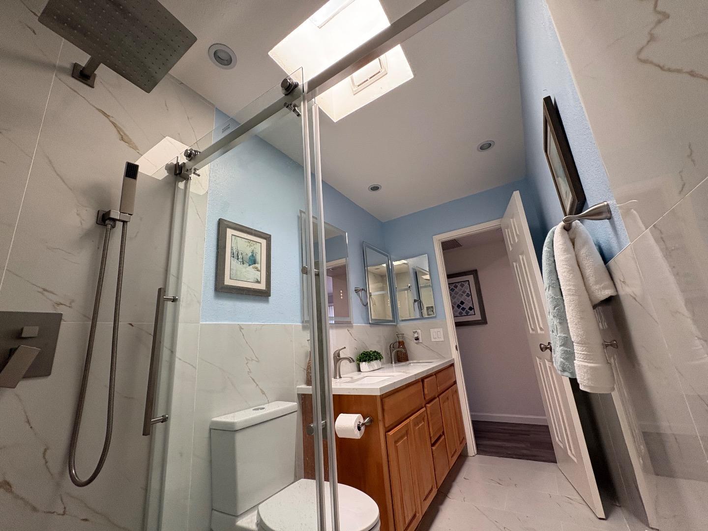 5187 Doyle Road San Jose, CA 95129 - Photo 20 of 39 a bathroom with sink a toilet a mirror and shower