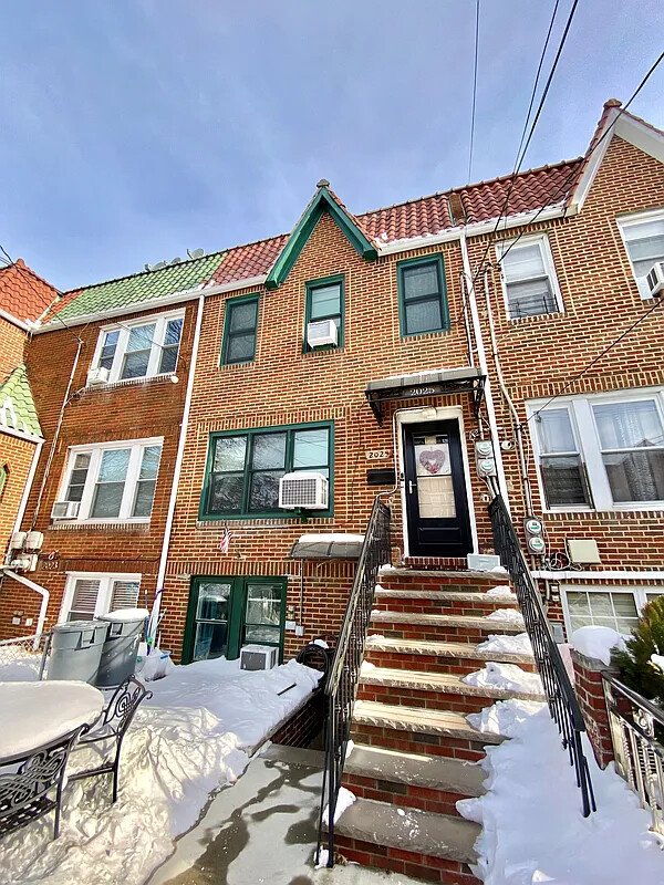 a front view of a residential apartment building with a yard