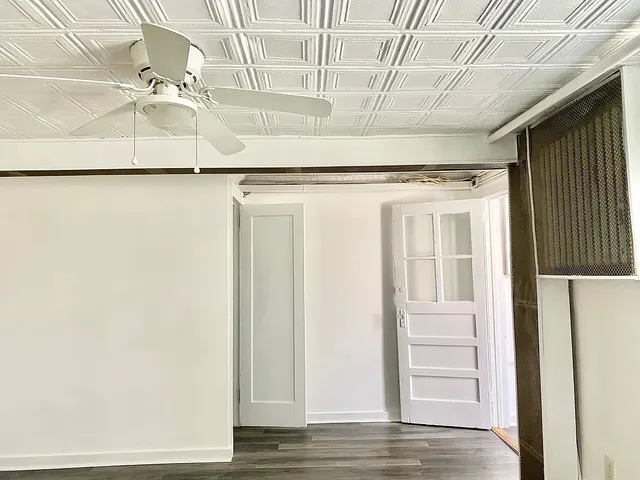 a view of a kitchen with wooden floor