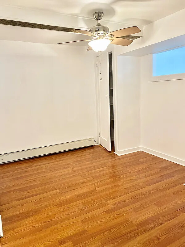 2025 East 34th Street, Unit 1 Brooklyn, NY 11234 - Photo 5 of 6 a view of an empty room with wooden floor