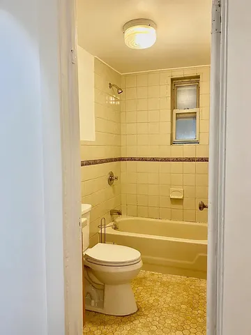 a bathroom with a toilet and shower