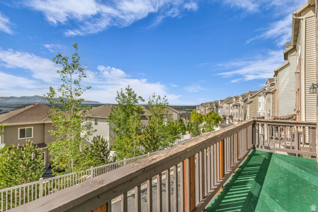 14108 Pepi Band Road Draper, UT 84020 - Photo 33 of 36 Outdoor balcony featuring a wooden railing, green artificial turf flooring, and a residential community backdrop