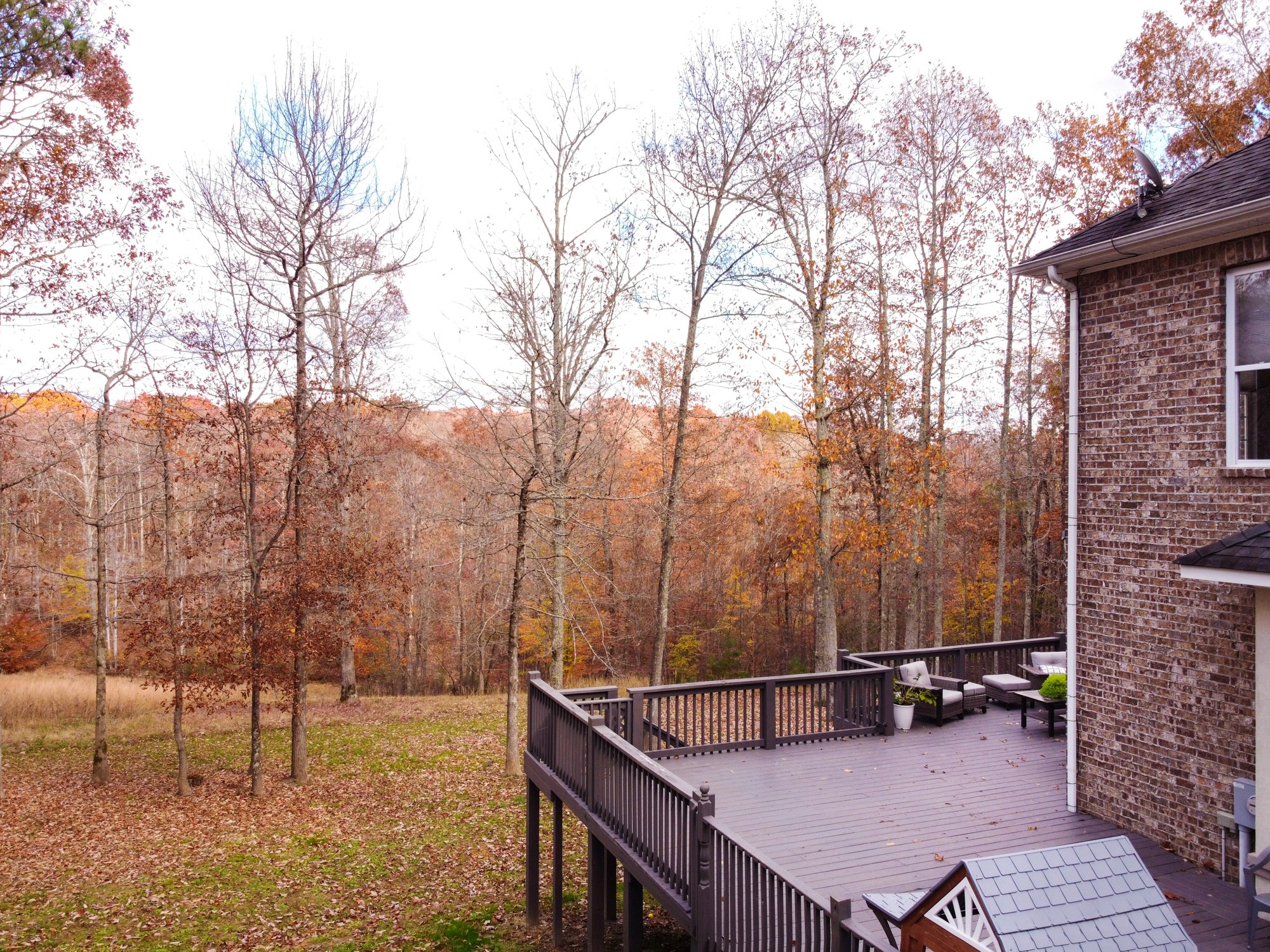 5061 Spears Road Centerville, TN 37033 - Photo 18 of 55 a view of a roof deck with wooden fence and a couple of chairs