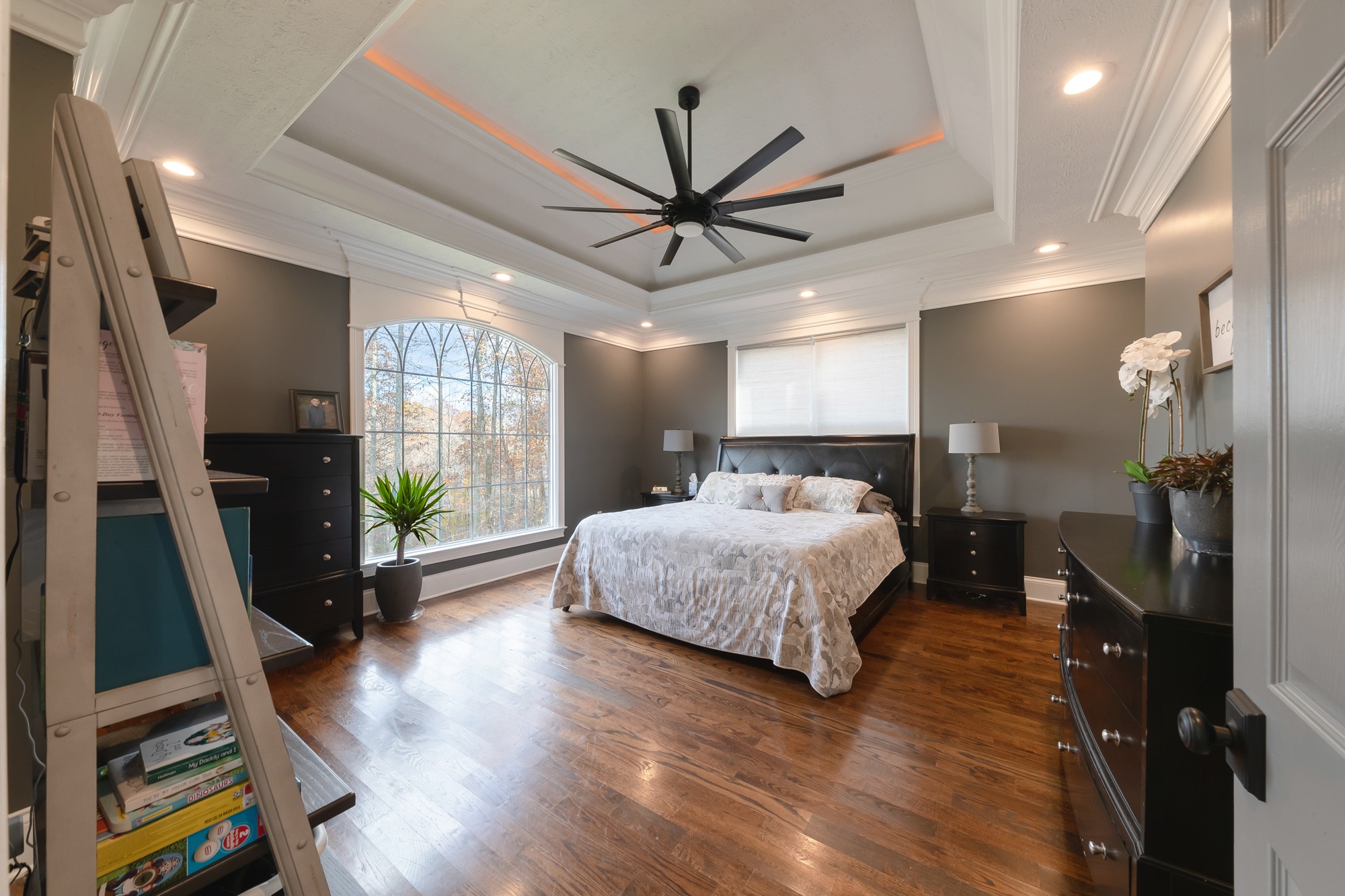 5061 Spears Road Centerville, TN 37033 - Photo 40 of 55 a spacious bedroom with a bed a large window closet and flat screen tv
