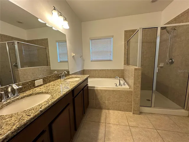 a bathroom with a granite countertop sink mirror and shower