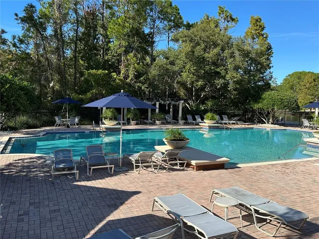 a swimming pool with outdoor seating and yard