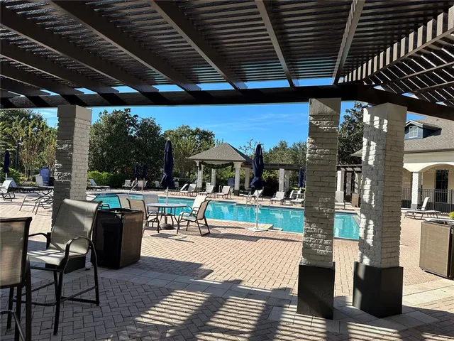 a view of a patio with dining table and chairs with wooden floor