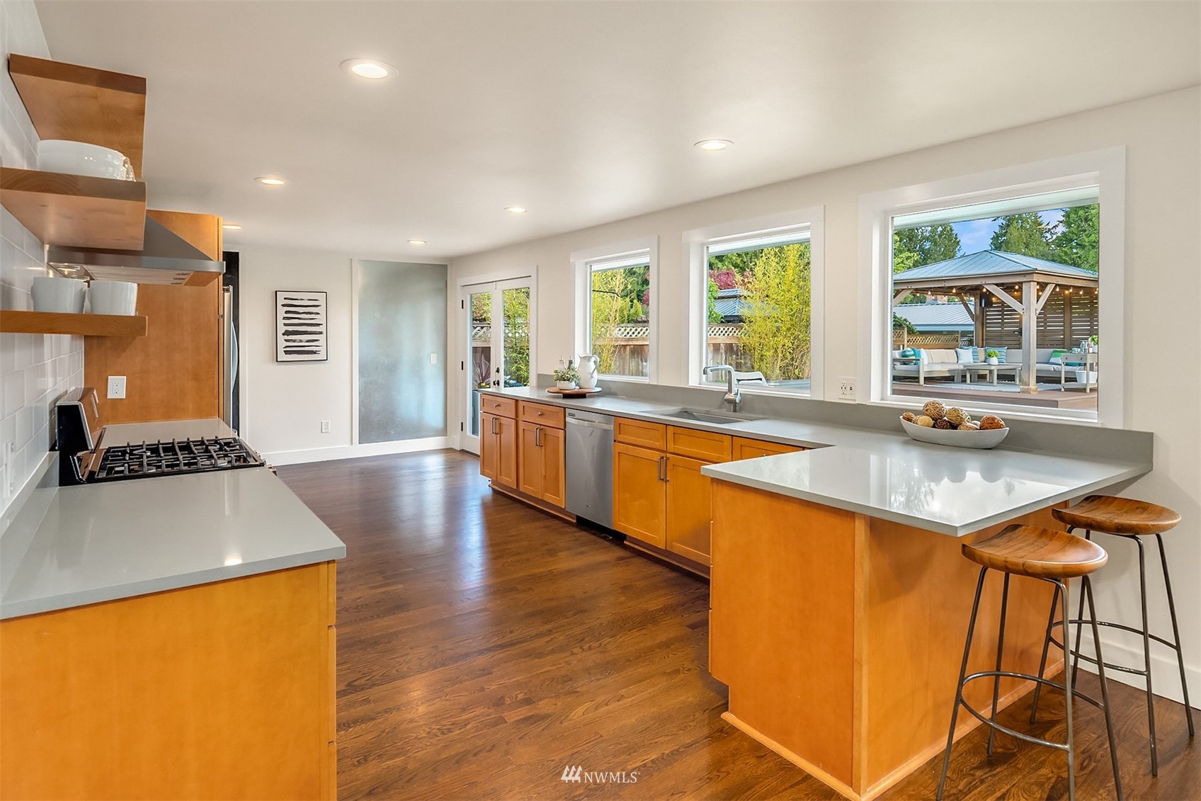 14217 Southeast 144th Street Renton, WA 98059 - Photo 12 of 30 a large kitchen with stainless steel appliances granite countertop a sink and a wooden cabinets