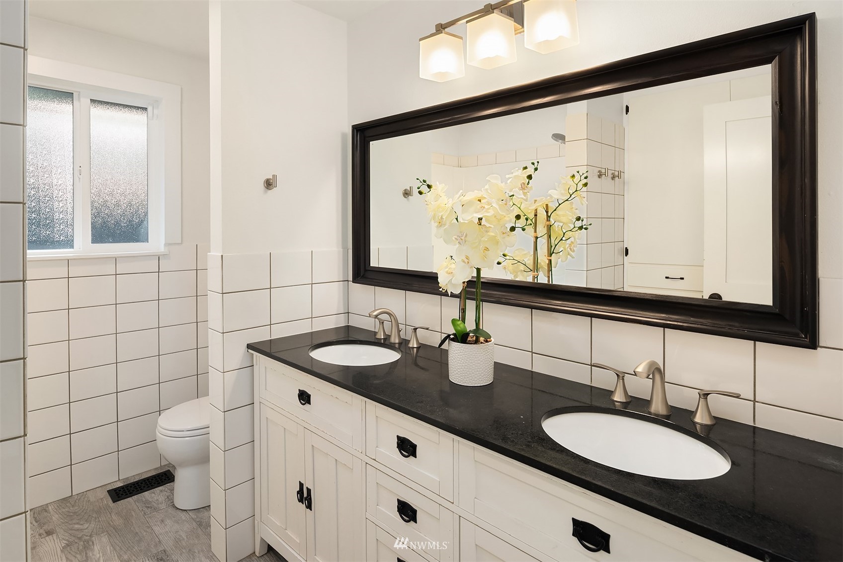 14217 Southeast 144th Street Renton, WA 98059 - Photo 17 of 30 a bathroom with a double vanity sink mirror and toilet