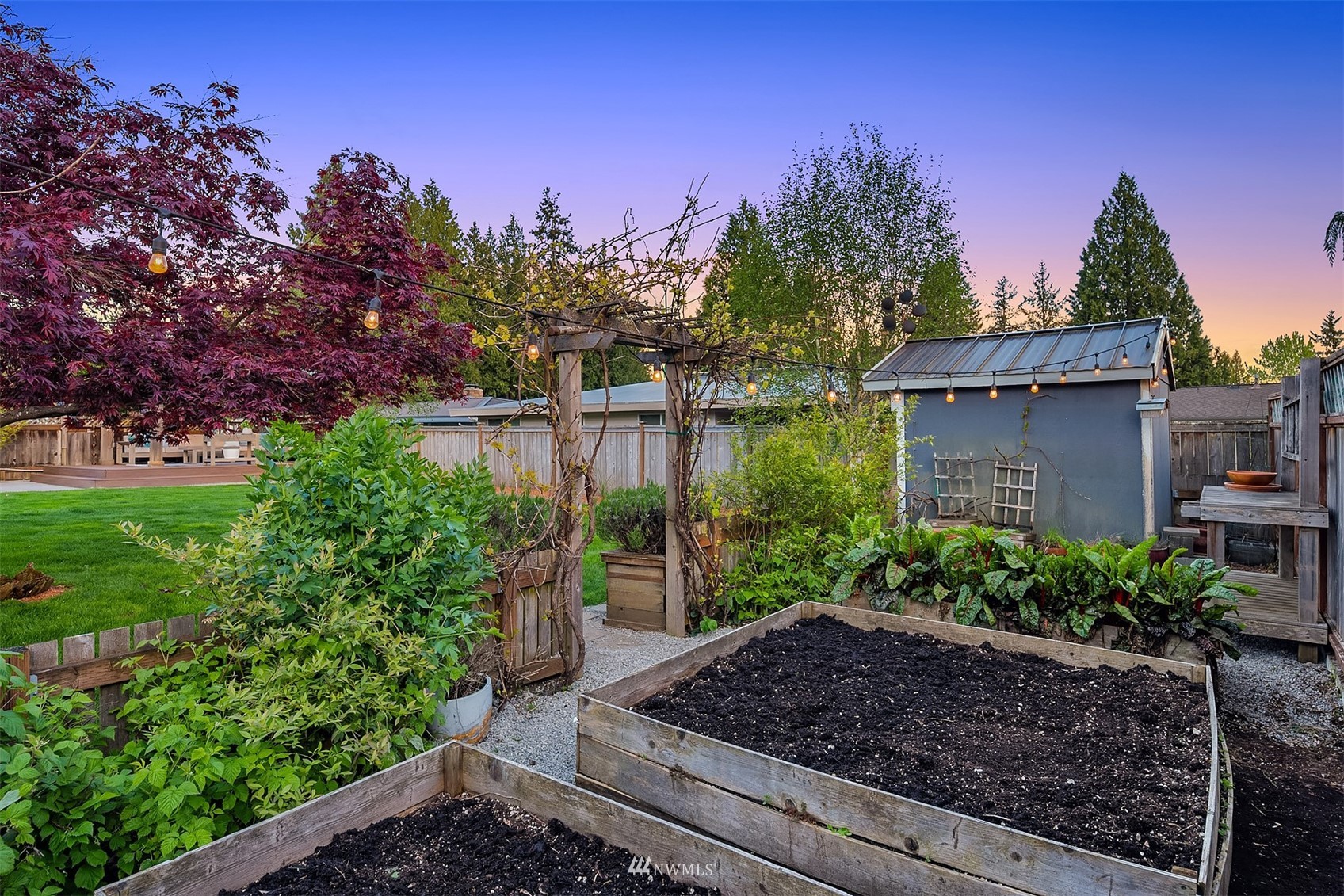 14217 Southeast 144th Street Renton, WA 98059 - Photo 22 of 30 a view of a garden with a house in the background