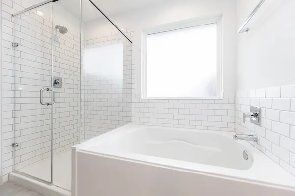 a white bath tub sitting next to a white sink