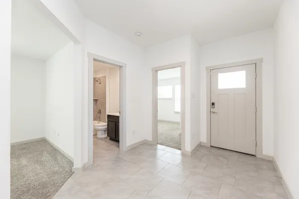 an empty room with closet and a bathroom