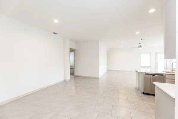 a view of kitchen with granite countertop cabinets and sink