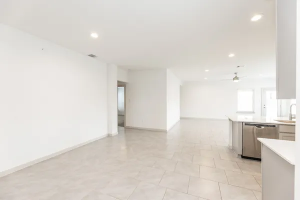 a view of kitchen with granite countertop cabinets and sink