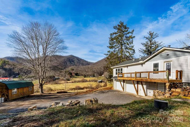 a view of a house with a yard covered with snow in the background