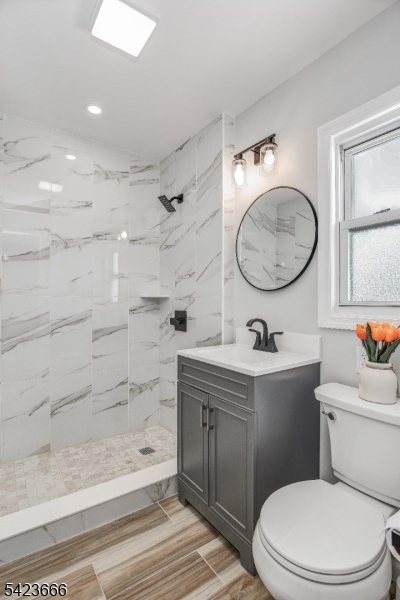 1017 Grandview Avenue Union, NJ 07083 - Photo 11 of 34 a bathroom with a granite countertop toilet a sink and a mirror
