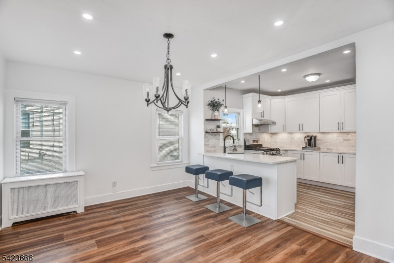 1017 Grandview Avenue Union, NJ 07083 - Photo 21 of 34 a kitchen with stainless steel appliances a white table chairs and a window
