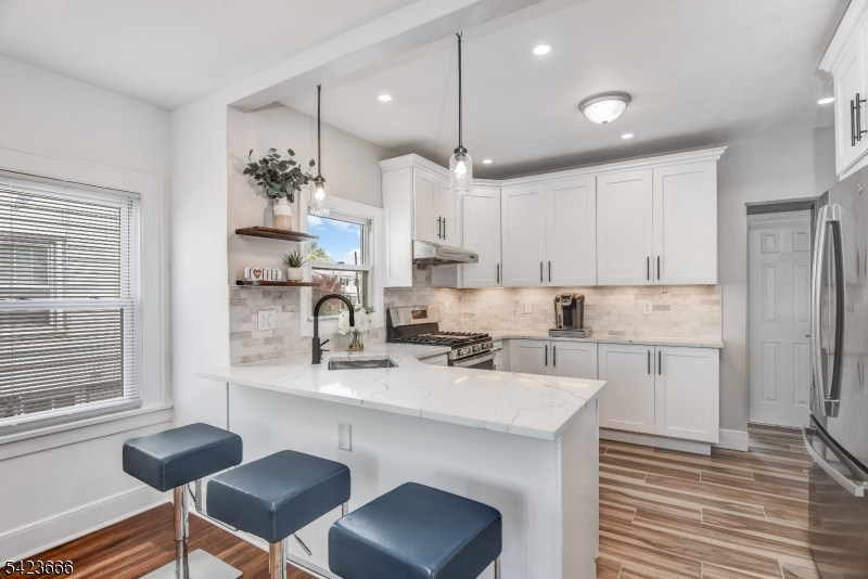 1017 Grandview Avenue Union, NJ 07083 - Photo 23 of 34 a kitchen with a sink cabinets stainless steel appliances and windows