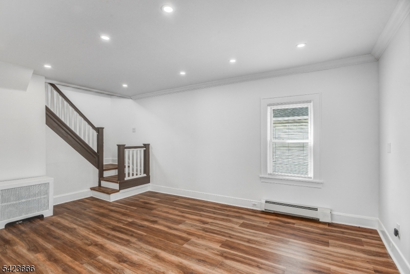 1017 Grandview Avenue Union, NJ 07083 - Photo 6 of 34 a view of empty room with wooden floor and fan
